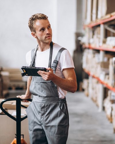 Young man working at a warehouse with boxes Young man working at a warehouse with boxes