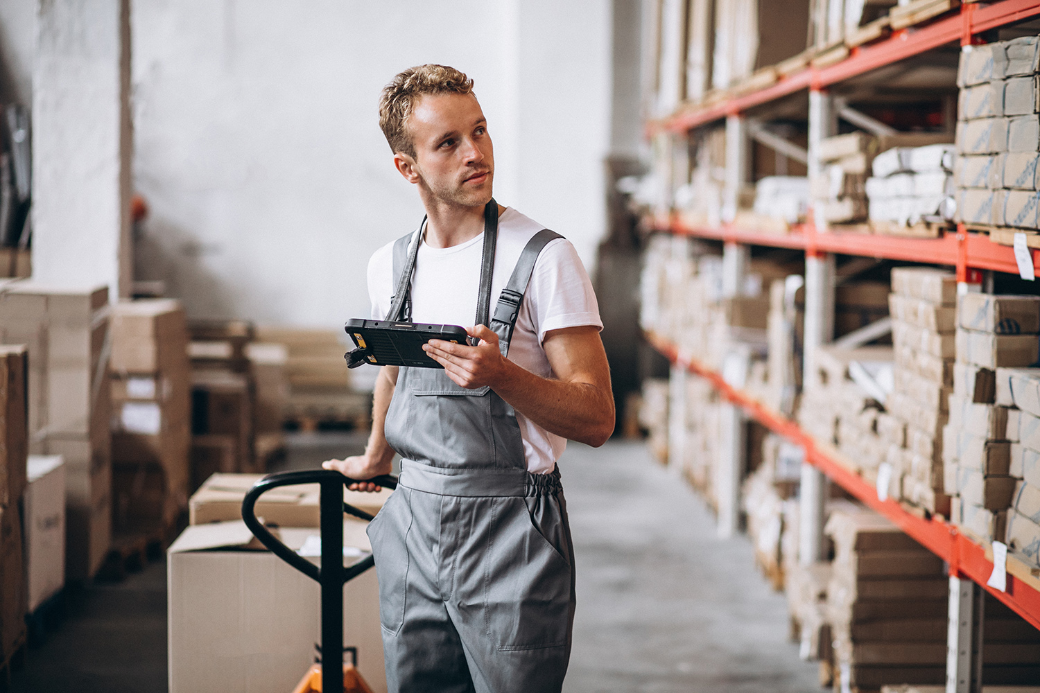Young man working at a warehouse with boxes Young man working at a warehouse with boxes